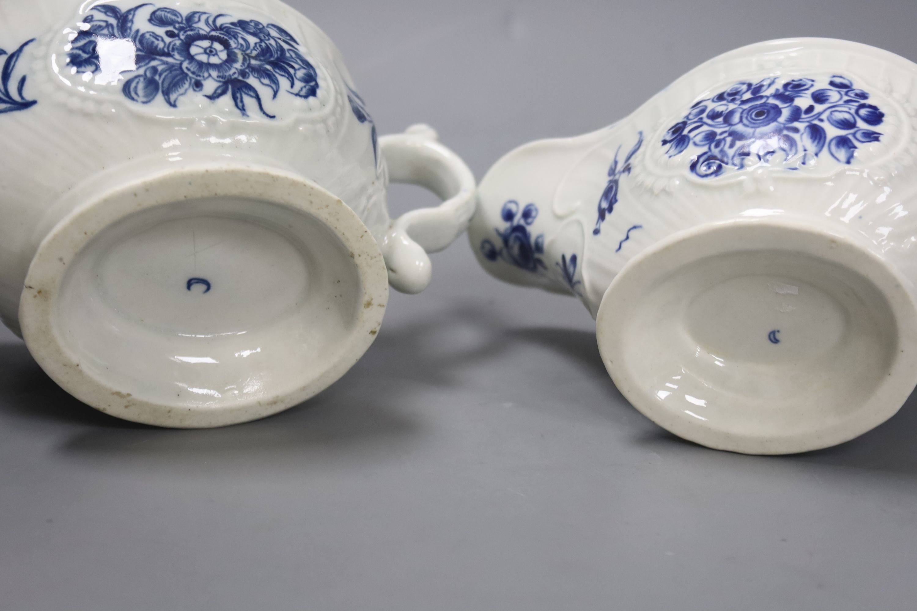 Two Worcester strap fluted floral sauceboats, c.1770, with scratch cross mark and crescent mark and the other crescent mark, height 17cm